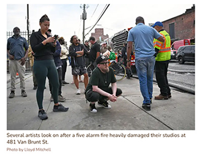 water cannons firing from a ship onto the warehouse building at 481 van brunt street in red hook